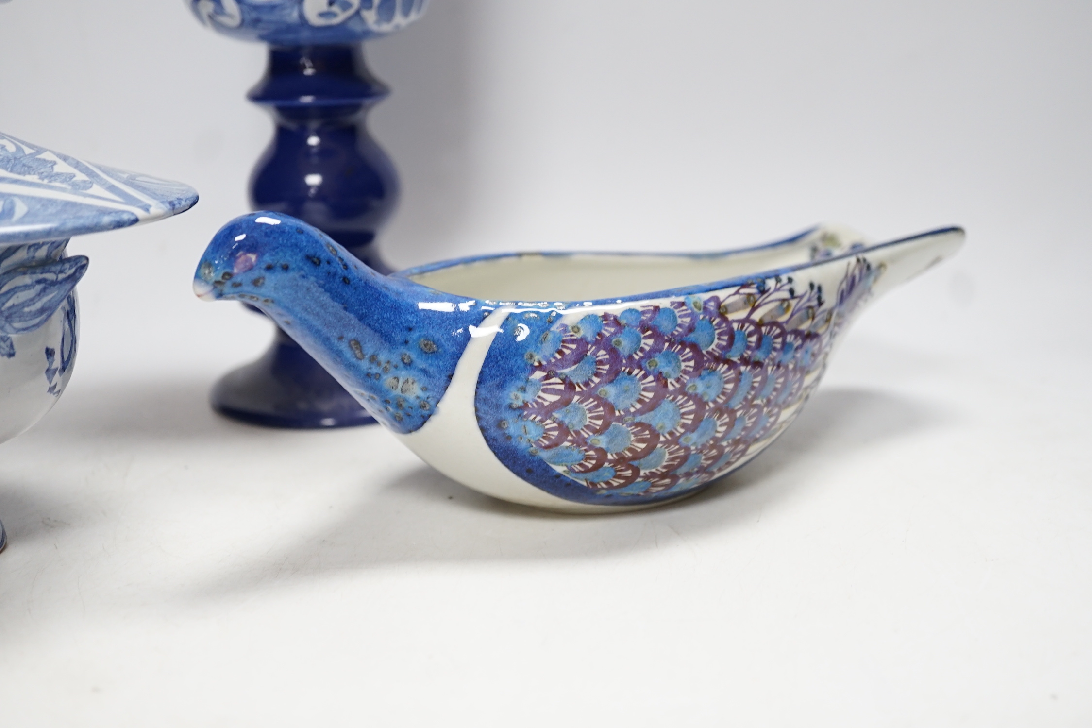 Two Danish ceramic items designed by Bjorn Wiinblad; a lidded pedestal cup in the form of a head with large hat and a candlestick, 26cm high, together with a bird sauce boat signed BJ on base (Berte Jesson)